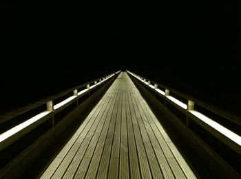 Surface level of jetty against dark background