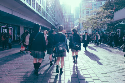 People walking on street in city