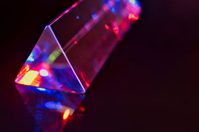 Close-up of illuminated lights against black background