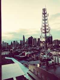 Aerial view of buildings in city against sky