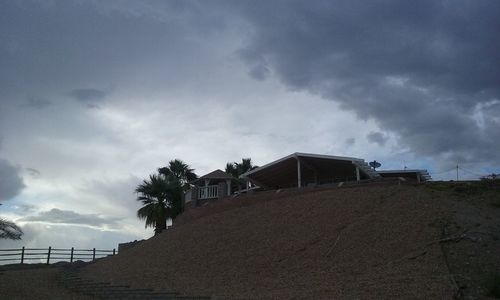 Low angle view of built structure against cloudy sky