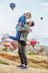 Couple in love stands on background of balloons in cappadocia. man and woman