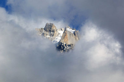 Low angle view of snowcapped mountain against sky