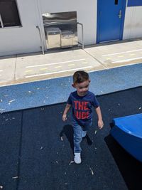 High angle view of cute boy standing outdoors