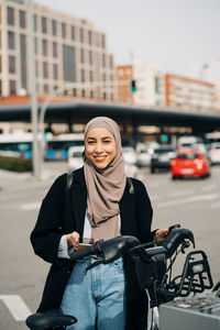 Full length of a smiling young woman in city