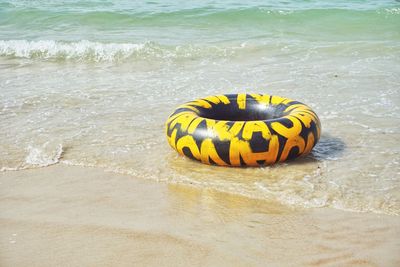 High angle view of yellow umbrella on beach