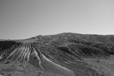 Scenic view of arid landscape against clear sky