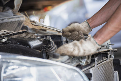 Midsection of man working on barbecue grill