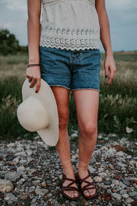 Low section of woman standing on rock