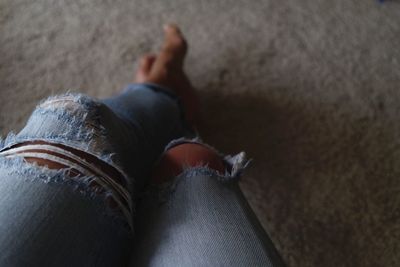 Low section of man wearing shoes