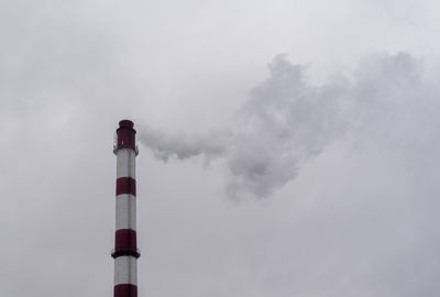 Low angle view of smoke stack against sky