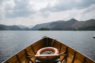 Scenic view of lake by mountains against sky