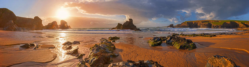 Panoramic view of beach against sky during sunset