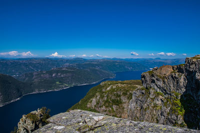 Scenic view of mountains against blue sky