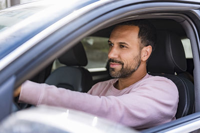 Portrait of man sitting in car