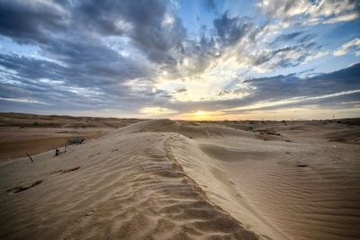 Scenic view of desert against dramatic sky