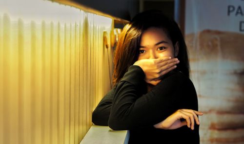 Portrait of beautiful woman standing at home