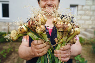 Midsection of person holding bouquet