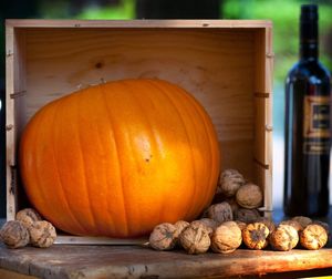 Pumpkin with walnuts on table