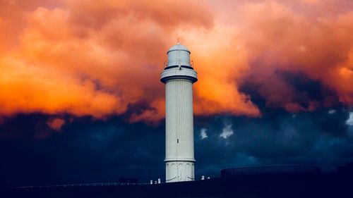 Low angle view of lighthouse against sky during sunset