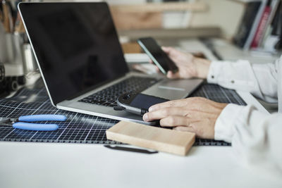 Cropped image of industrial designer making solar product at home office