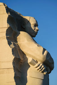 Low angle view of statue against clear blue sky