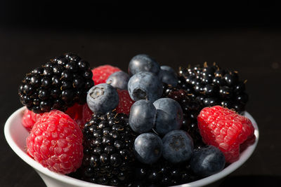 Close-up of strawberries on table against black background