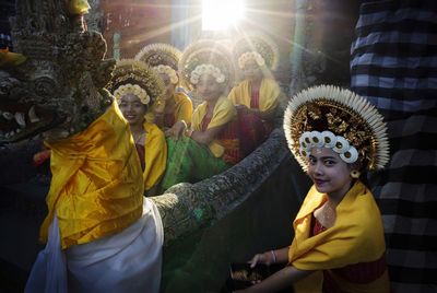 Balineese rejang dancer sitting under sunset