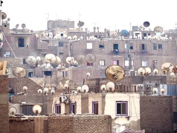 Buildings in city against clear sky