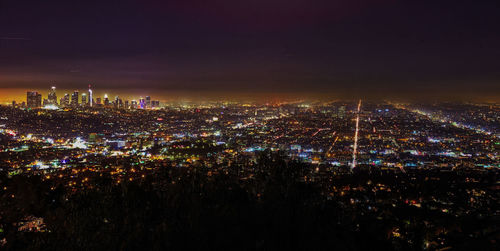 High angle view of city lit up at night