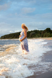 Pregnant woman on beach