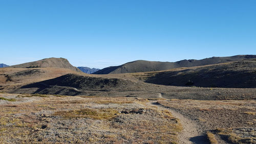 Scenic view of mountains against clear blue sky