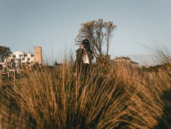 Man standing on field against clear sky