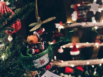 Christmas decorations hanging on tree at night