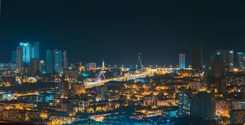 Illuminated buildings in city at night