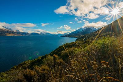 Scenic view of sea and mountains against sky