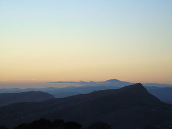 Scenic view of silhouette mountains against clear sky