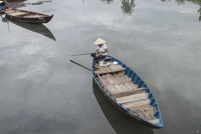 High angle view of fisherman on boat at river