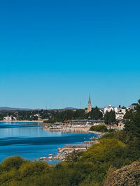 A beautiful blue ocean with a small town in the background. bariloche