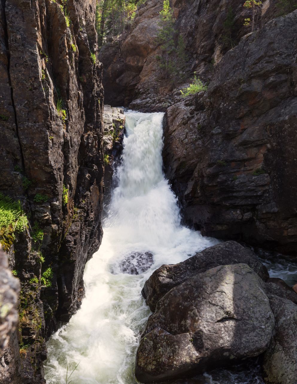 SCENIC VIEW OF WATERFALL ON ROCK FORMATION