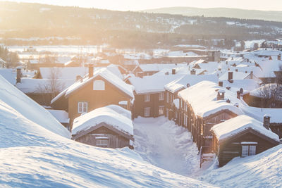 Snow covered houses and buildings in city