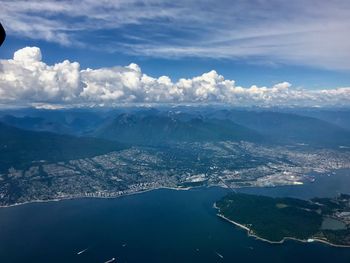 Aerial view of sea and mountains against sky