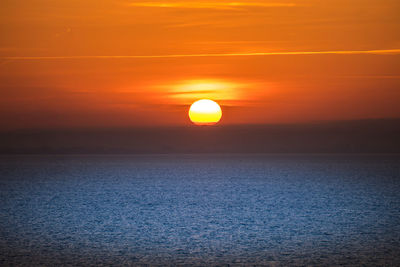 Scenic view of sea against romantic sky at sunset