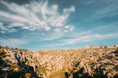 Rocks on landscape against sky