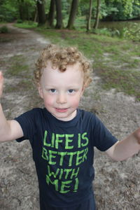 Portrait of cute boy standing on field