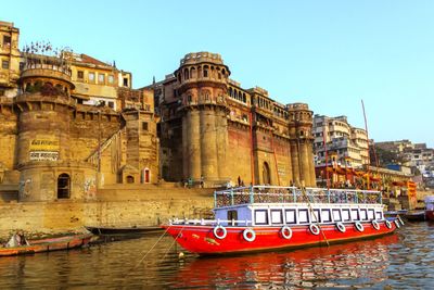 View of boats in river against buildings