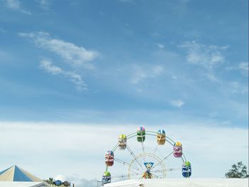 Low angle view of ferris wheel against sky