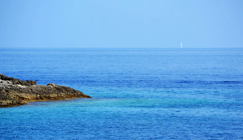 Scenic view of sea against clear blue sky