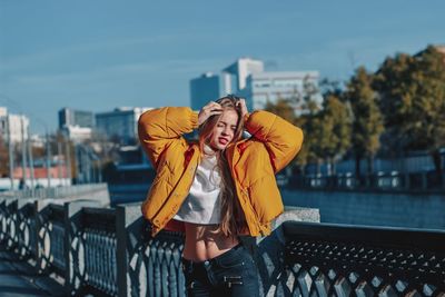 Young woman posing by railing