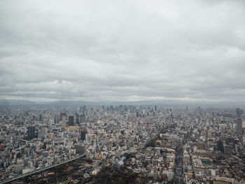 Aerial view of buildings in city against sky